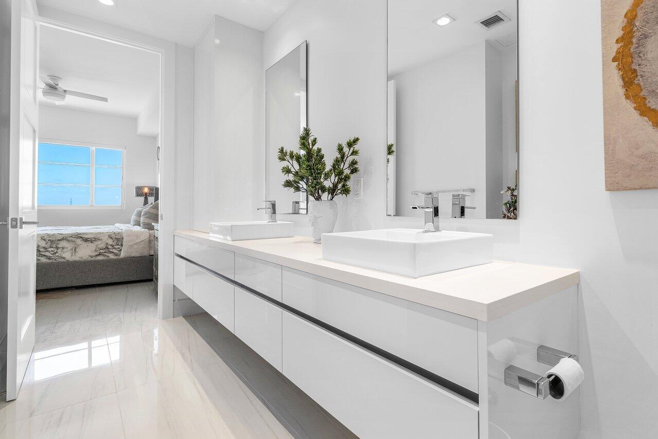 155 East Boca Raton Road, Unit 919 Boca Raton, FL 33432 - Photo 18 of 45 a bathroom with a sink and a mirror