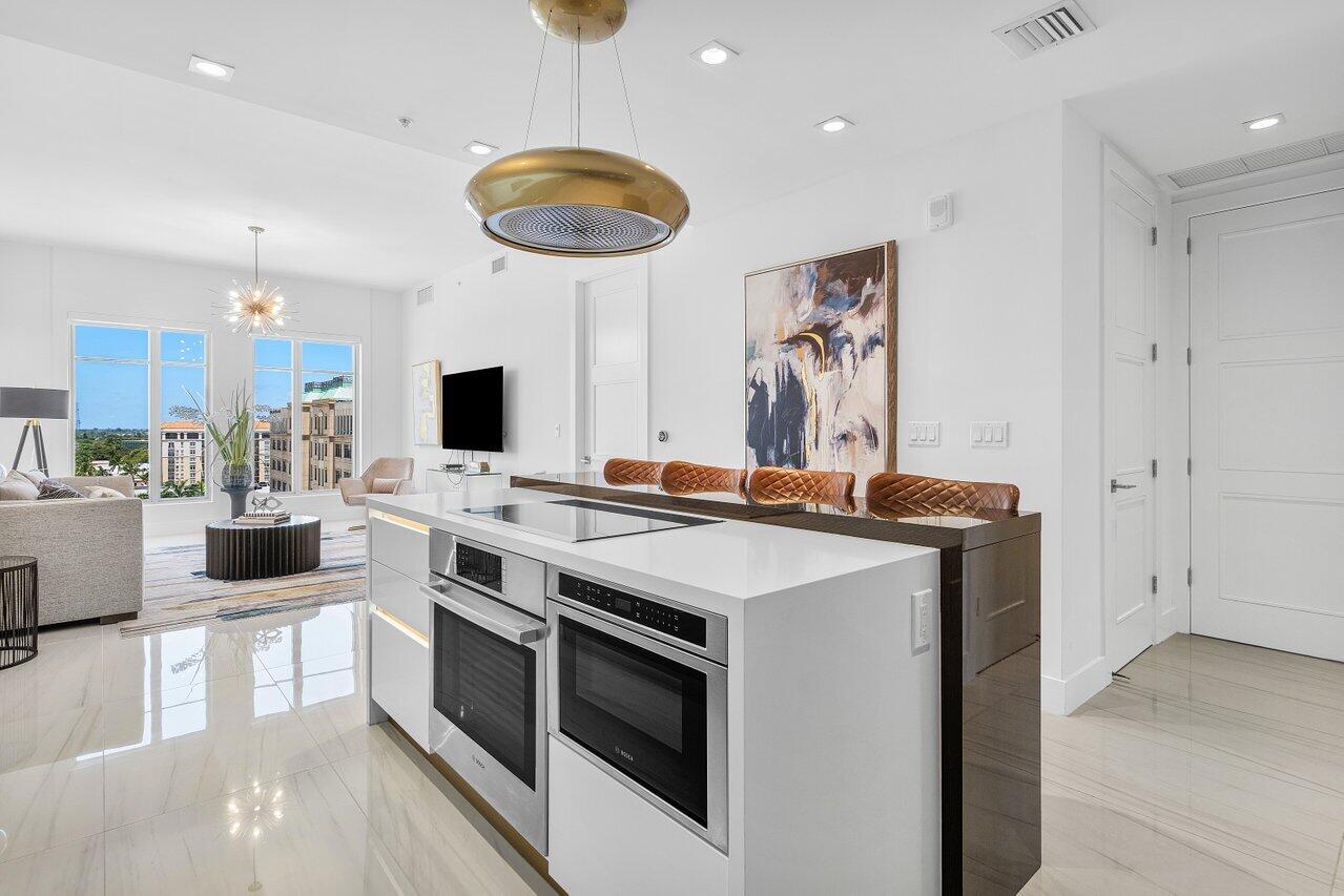 155 East Boca Raton Road, Unit 919 Boca Raton, FL 33432 - Photo 5 of 45 a kitchen with a stove and a view of living room