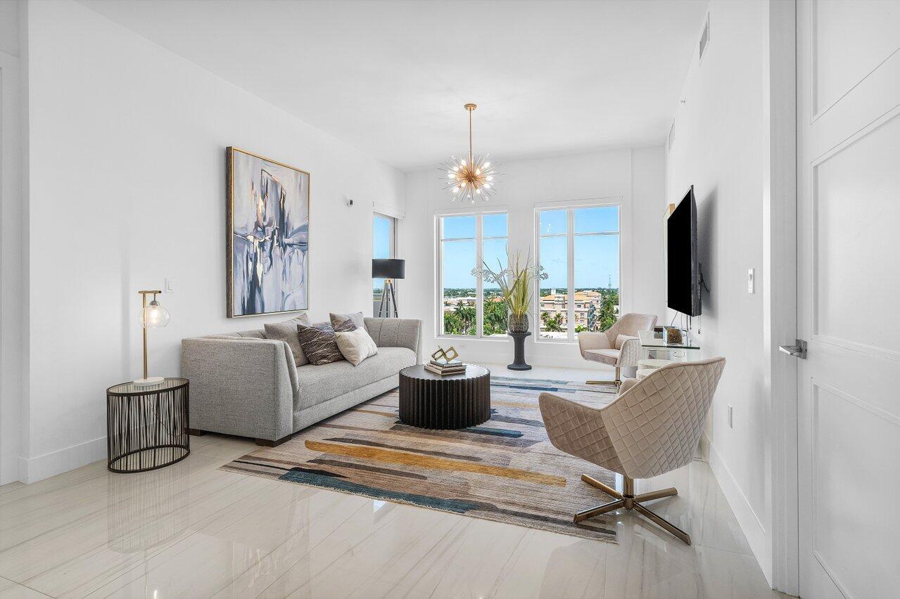 155 East Boca Raton Road, Unit 919 Boca Raton, FL 33432 - Photo 9 of 45 a living room with furniture a flat screen tv and a fireplace