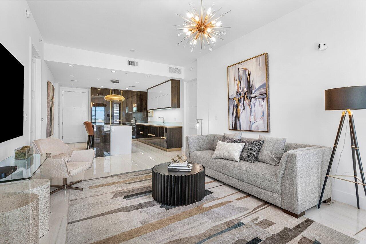 155 East Boca Raton Road, Unit 919 Boca Raton, FL 33432 - Photo 10 of 45 a living room with fireplace furniture and a flat screen tv