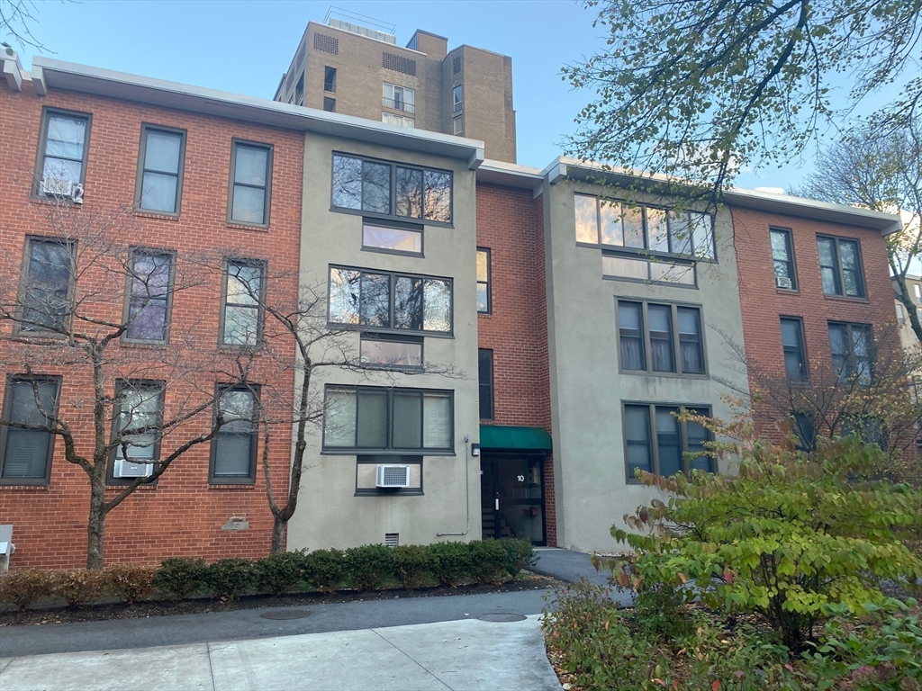 a front view of a residential apartment building with a yard