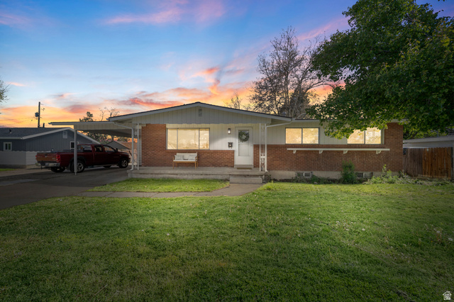 2267 West 4350th Street South Roy, UT 84067 - Photo 1 of 32 View of front of property featuring brick siding, a carport, driveway, and covered porch
