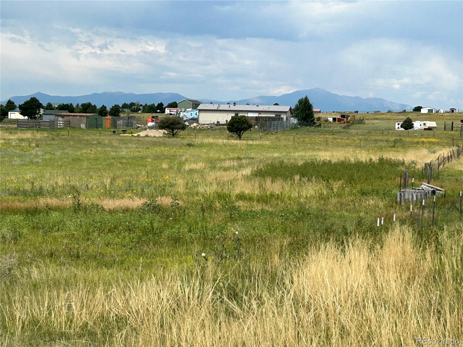 3640 Murr Road Peyton, CO 80831 - Photo 3 of 22 a view of a lake with houses in the back