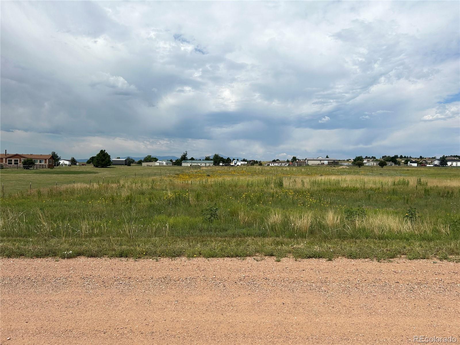 3640 Murr Road Peyton, CO 80831 - Photo 8 of 22 a view of a lake with houses in the back