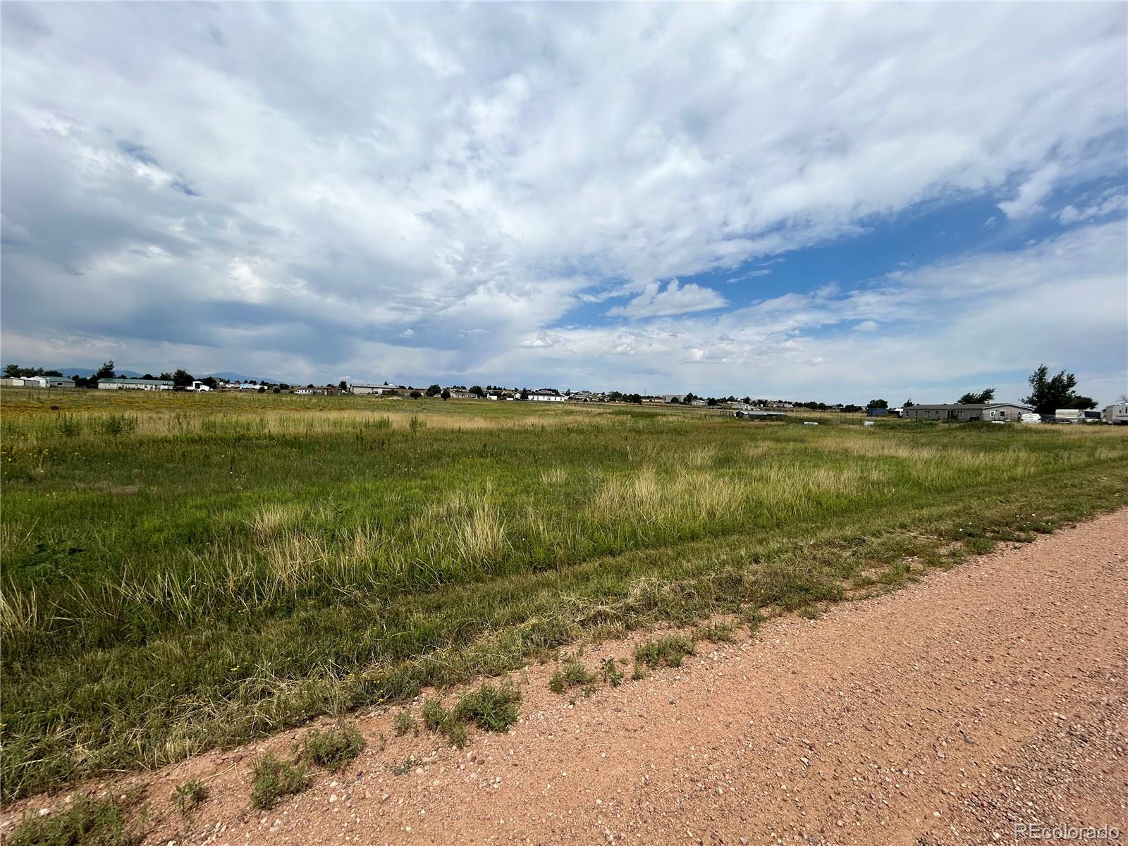3640 Murr Road Peyton, CO 80831 - Photo 10 of 22 a view of a lake with houses in the back