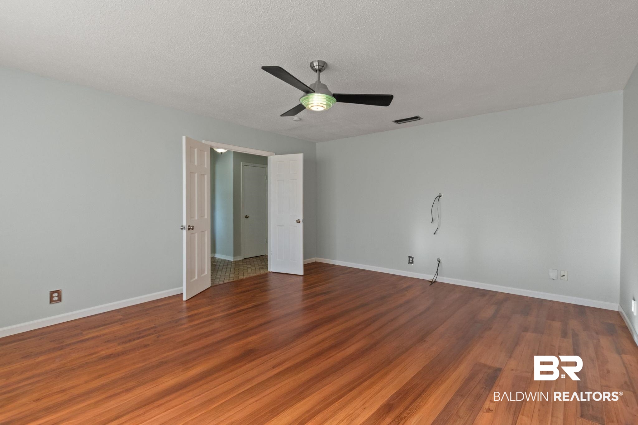 3864 Leroy Stevens Road Mobile, AL 36619 - Photo 14 of 33 Unfurnished bedroom with dark wood-style flooring, ceiling fan, and a textured ceiling