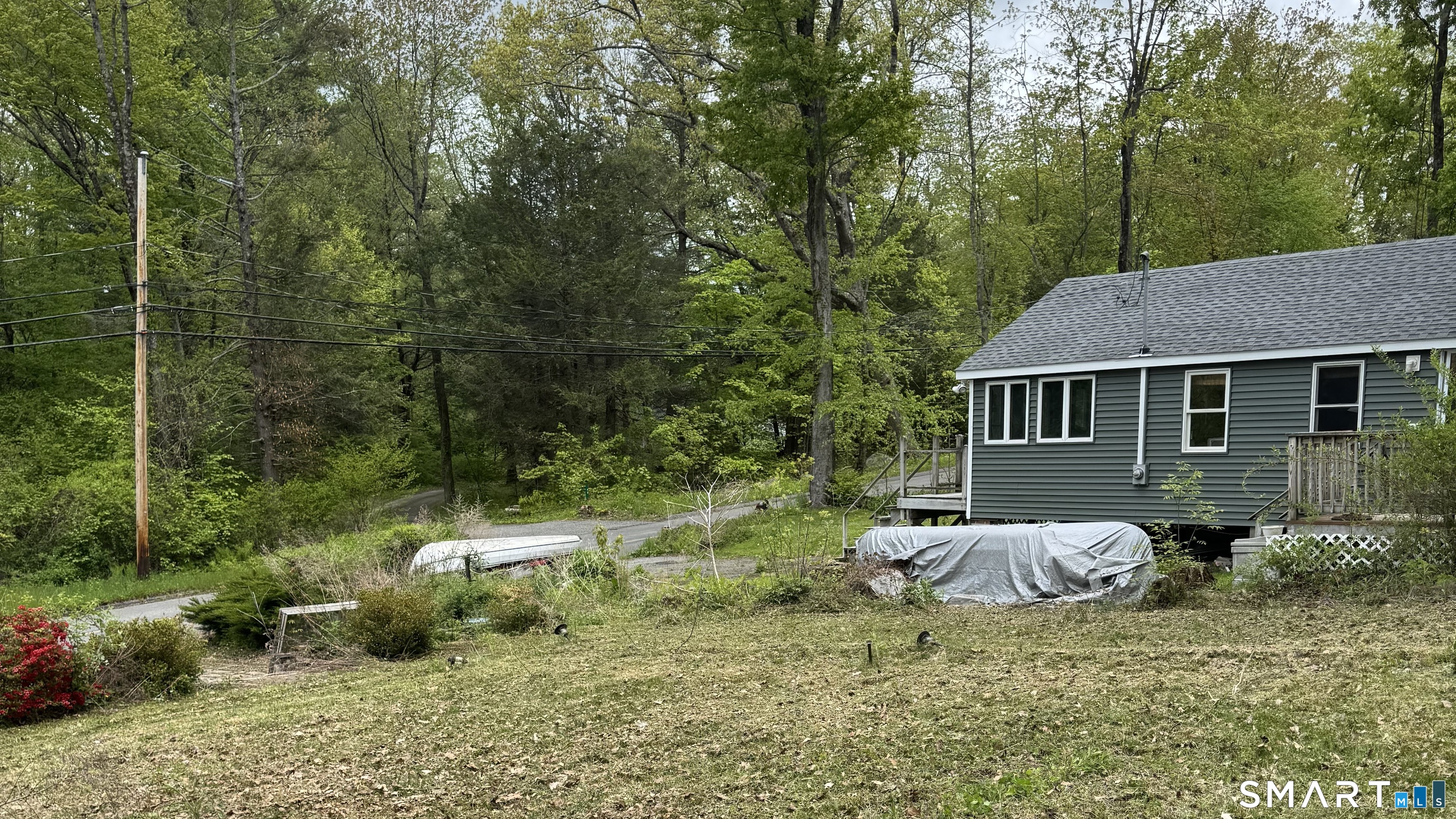 12 Hilltop Road New Hartford, CT 06057 - Photo 3 of 4 a backyard of a house with table and chairs