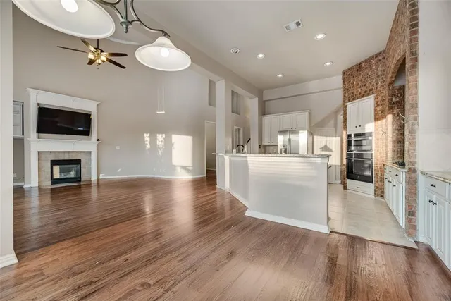 a view of a kitchen with wooden floor and a kitchen view