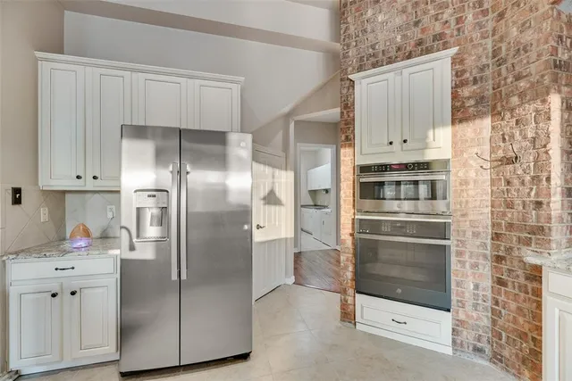 a kitchen with stainless steel appliances cabinets and a refrigerator