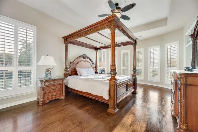 a bedroom with a bed and a large window with the outer view