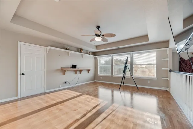a view of a livingroom with a ceiling fan and hardwood floor