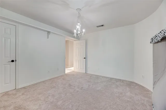 a view of an empty room with chandelier