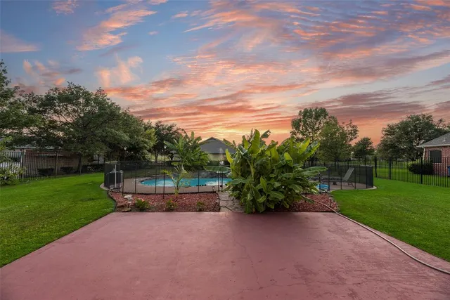 a backyard of a house with lots of green space and garden