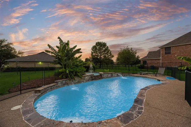 a view of a swimming pool with a yard