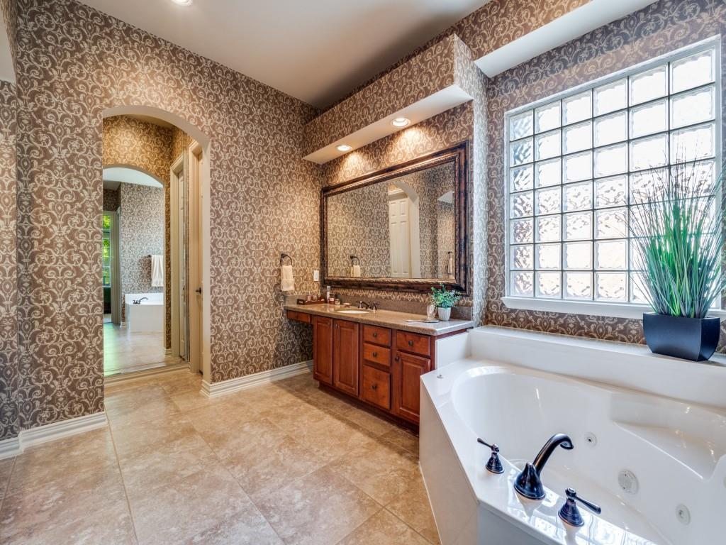 6470 Hunters Parkway Frisco, TX 75035 - Photo 23 of 40 Bathroom featuring double vanity, a jetted tub, wallpapered walls, and light tile patterned floors