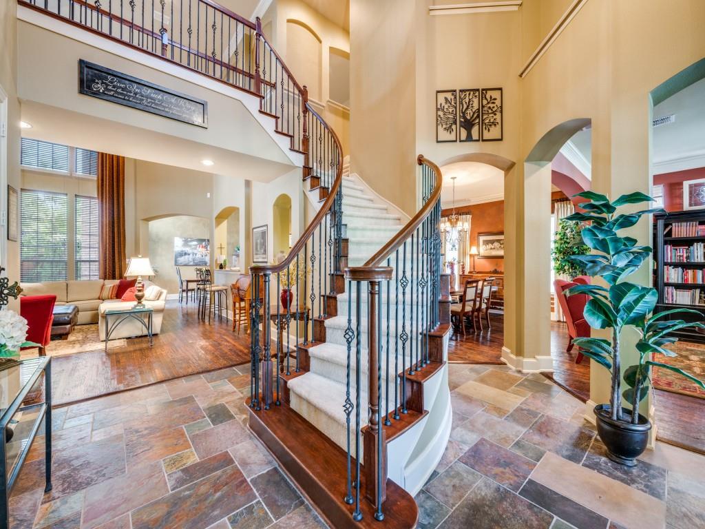 6470 Hunters Parkway Frisco, TX 75035 - Photo 5 of 40 Foyer entrance featuring arched walkways, a towering ceiling, stone tile flooring, and stairs
