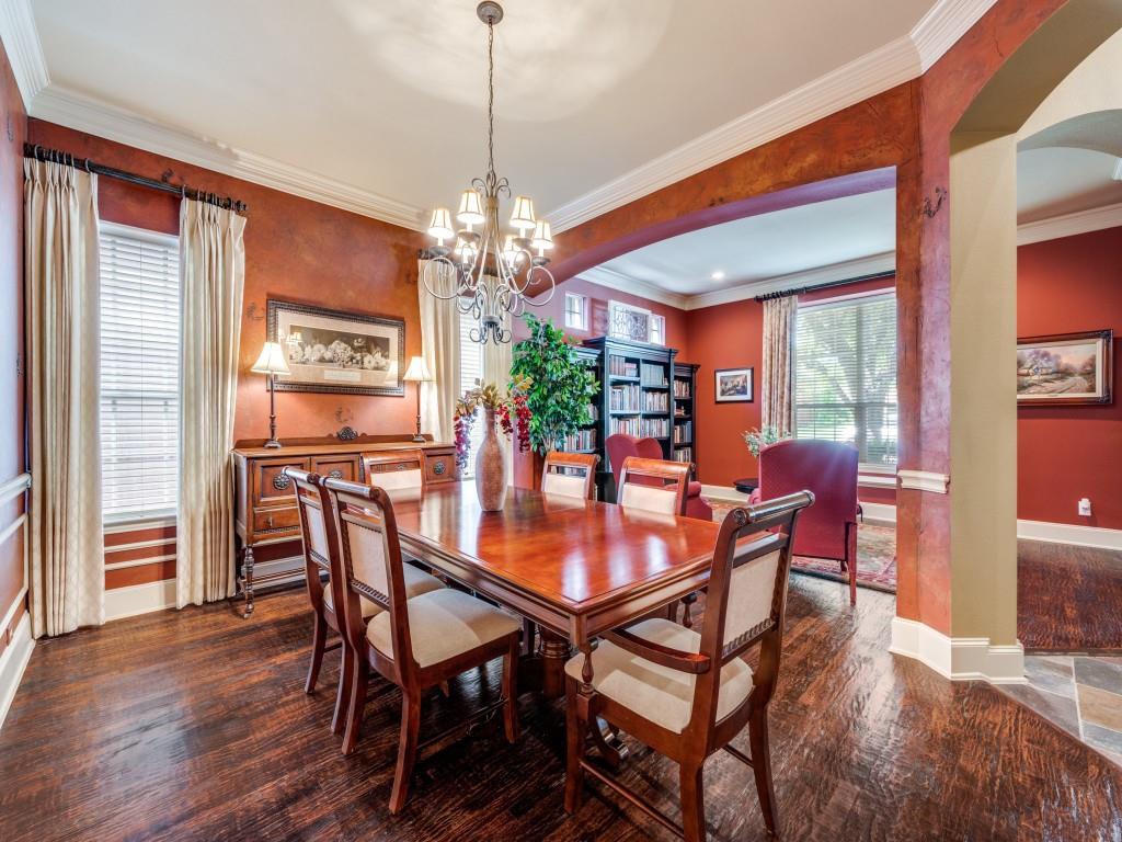 6470 Hunters Parkway Frisco, TX 75035 - Photo 9 of 40 Dining room with arched walkways, ornamental molding, dark wood-type flooring, and a chandelier