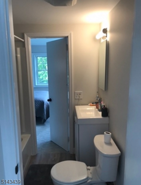 1 Union Avenue, Unit 3 Madison, NJ 07940 - Photo 8 of 12 a bathroom with a toilet sink and mirror