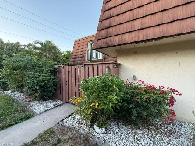 a view of a house with a flower garden