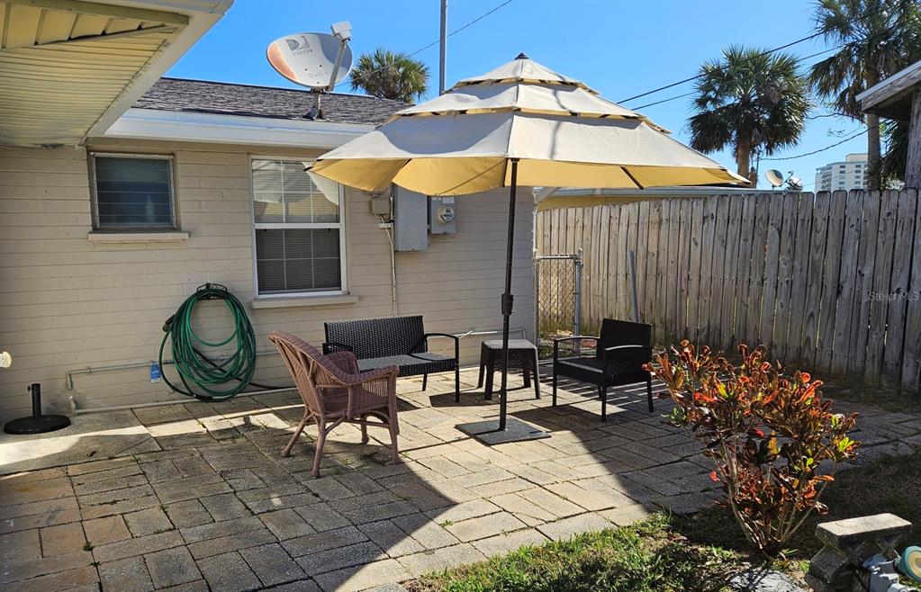 37 Rivershore Drive Ormond Beach, FL 32176 - Photo 26 of 36 a view of a chairs and table in backyard