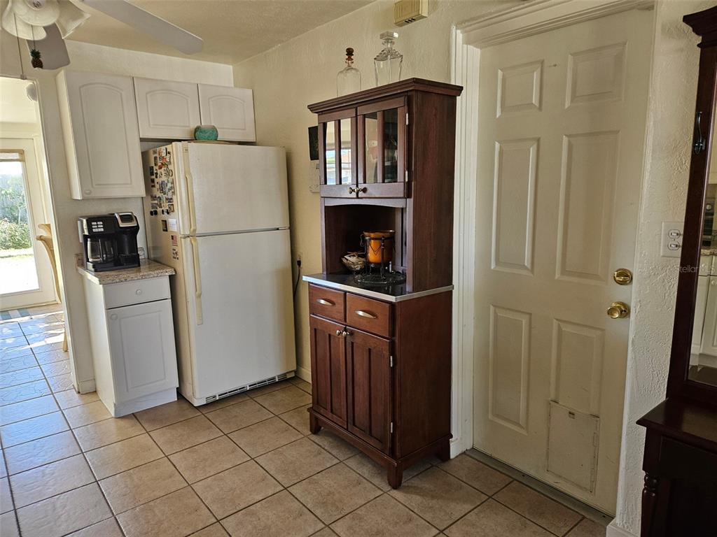 37 Rivershore Drive Ormond Beach, FL 32176 - Photo 8 of 36 a kitchen with a refrigerator a washer and dryer