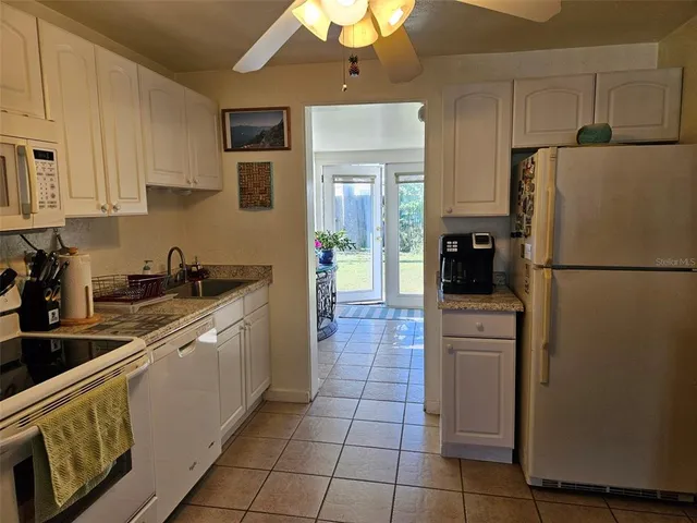 a kitchen with stainless steel appliances granite countertop a sink a stove and cabinets