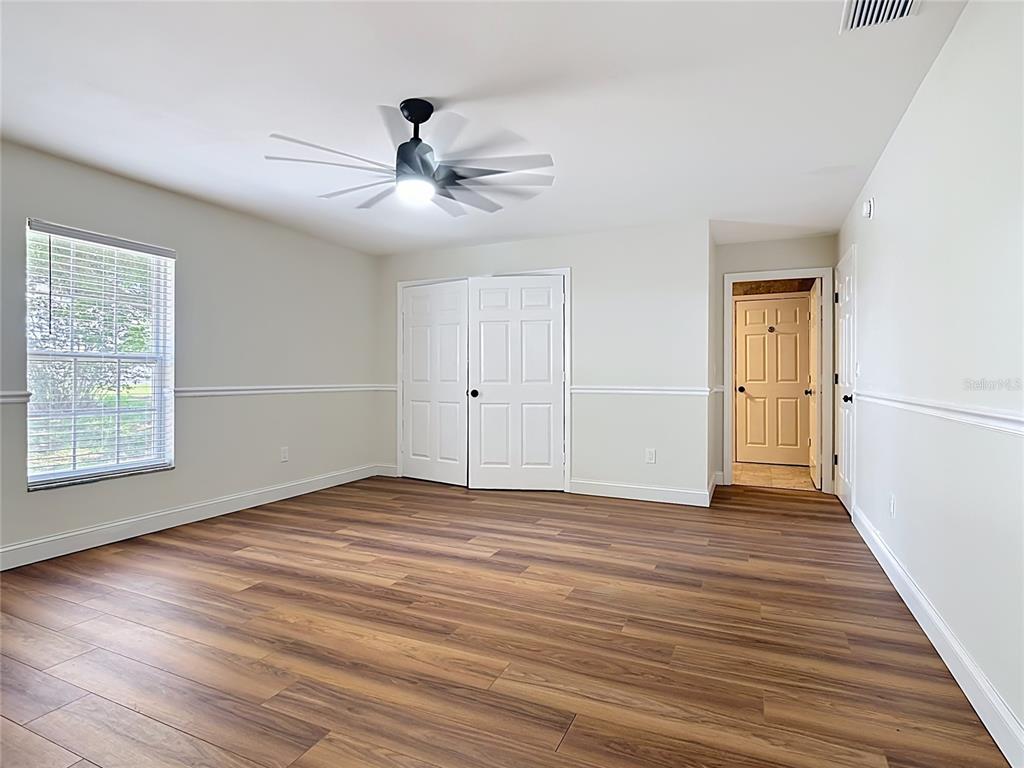 7925 Lake Mabel Loop Road Lake Wales, FL 33898 - Photo 63 of 97 a view of an empty room with wooden floor and a window