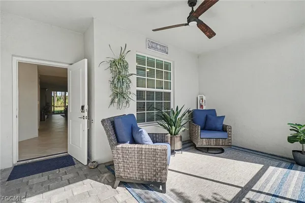 a living room with furniture and a potted plant