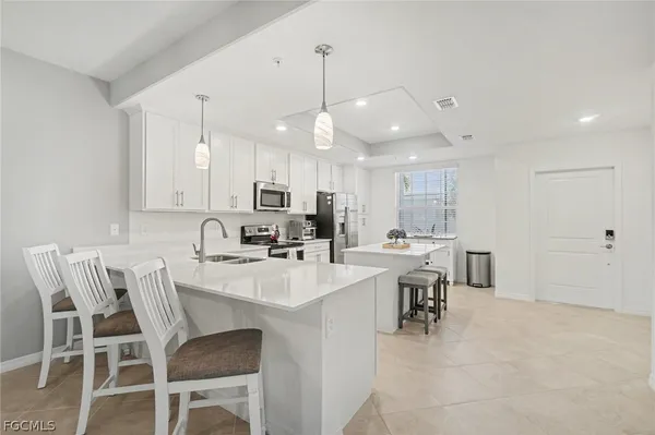 a view of kitchen with cabinets table and chairs