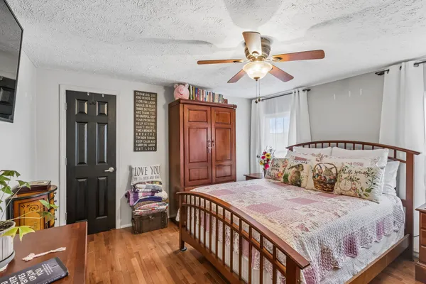 a view of a dining room and livingroom with furniture wooden floor a chandelier