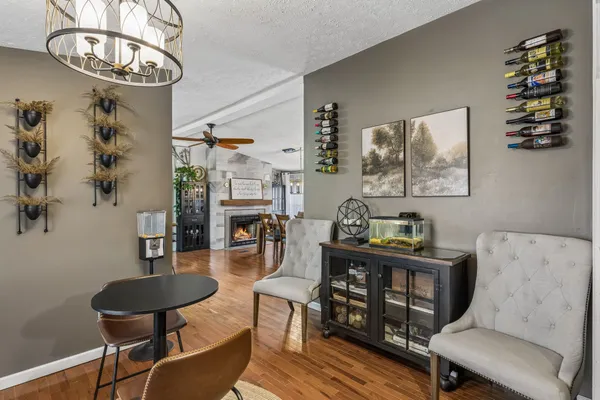 a kitchen with stainless steel appliances granite countertop a stove a refrigerator a sink a stove and island with wooden floor