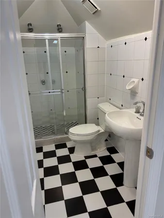 a bathroom with a sink a toilet and a mirror