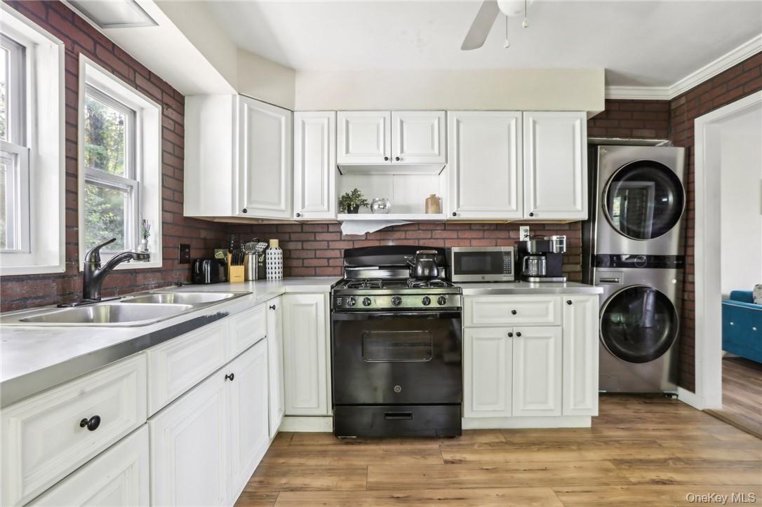 5 Beverly Trail Monroe, NY 10950 - Photo 13 of 24 a kitchen with a stove top oven sink and cabinets