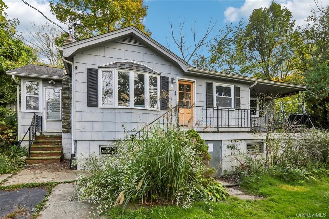 5 Beverly Trail Monroe, NY 10950 - Photo 2 of 24 a view of a house with brick walls and a yard with plants and a table and chairs