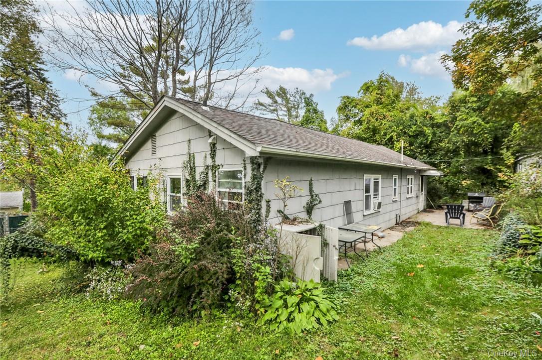 5 Beverly Trail Monroe, NY 10950 - Photo 23 of 24 a white house with a small yard plants and large trees