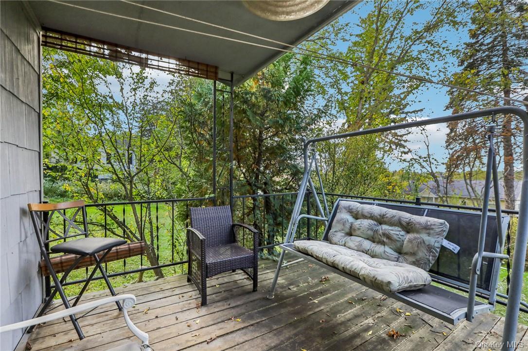 5 Beverly Trail Monroe, NY 10950 - Photo 4 of 24 a balcony with wooden floor and outdoor seating