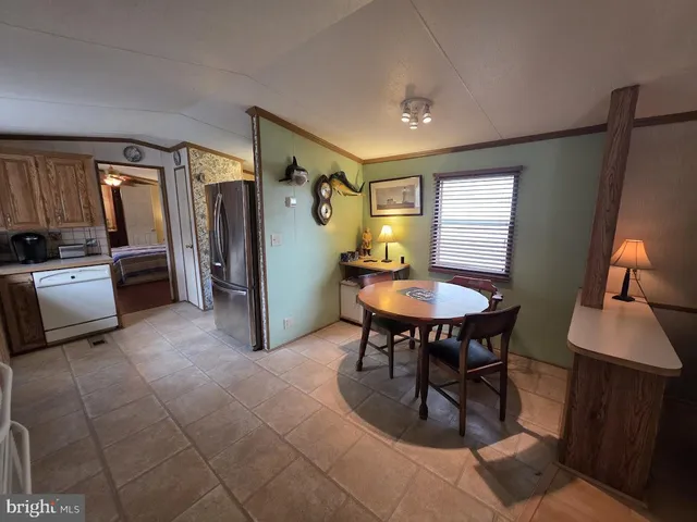 a kitchen with a refrigerator and a stove top oven