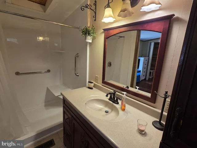 a bathroom with a sink vanity and a mirror