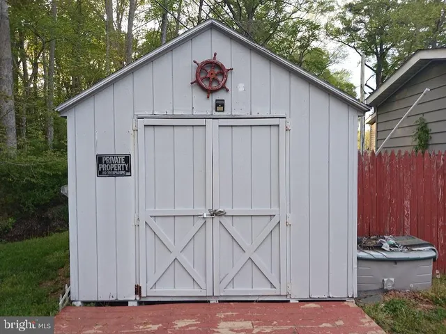 a white house with tree in front of it