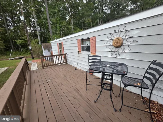 a view of balcony with wooden floor and outdoor seating