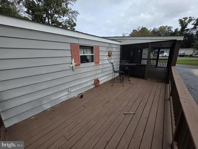 a balcony with wooden floor and furniture