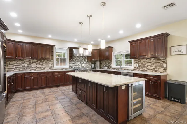 a kitchen with stainless steel appliances granite countertop wooden cabinets a sink and a stove