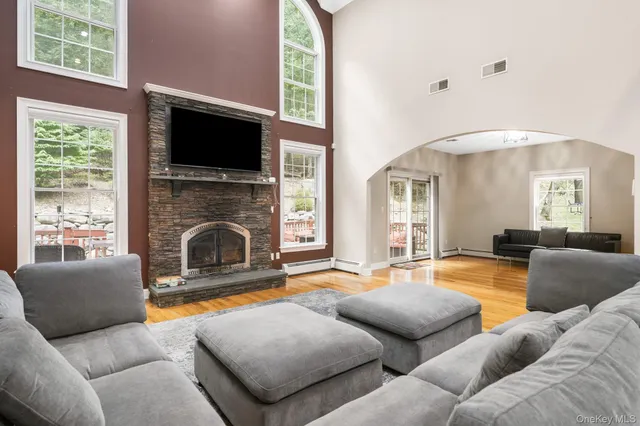 a living room with furniture flat screen tv and a fireplace
