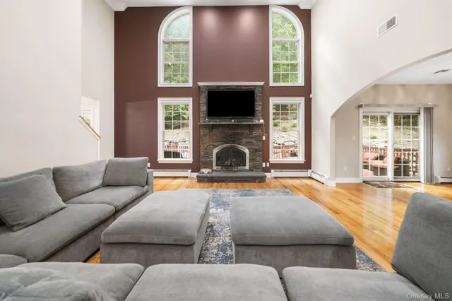 a living room with furniture fireplace and flat screen tv