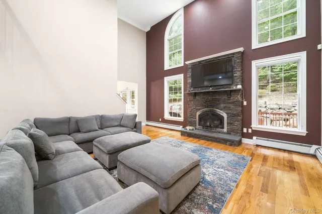 a living room with furniture a flat screen tv and a fireplace