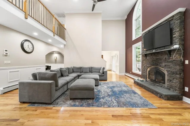 a living room with furniture flat screen tv and a fireplace
