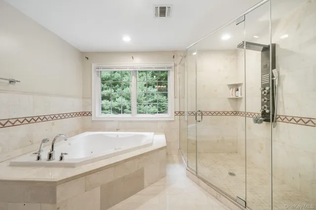 a bathroom with a tub sink and shower
