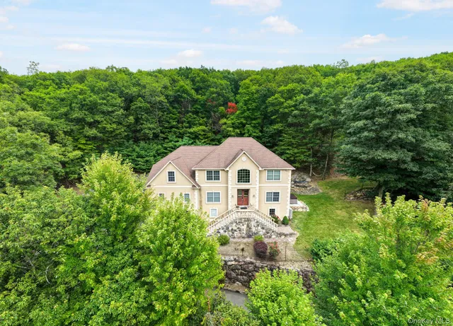 a view of a garden with a house in the background