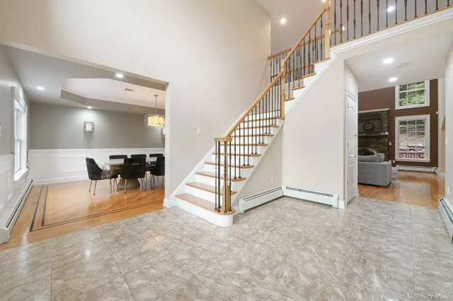a view of a hallway with dining room and stairs