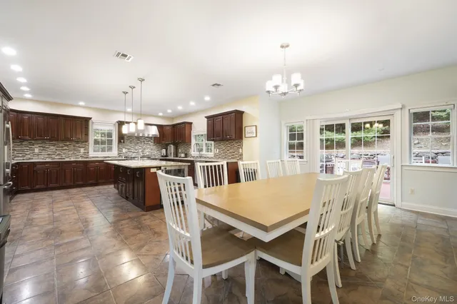 a large kitchen with a table and chairs